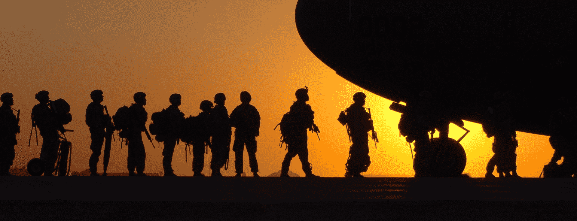 military servicemembers boarding a plane