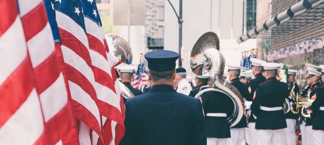 American flags near a military band playing brass instruments
