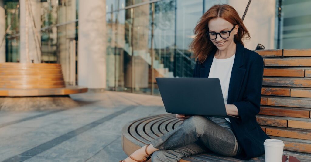 Woman On Bench Outside Laptop