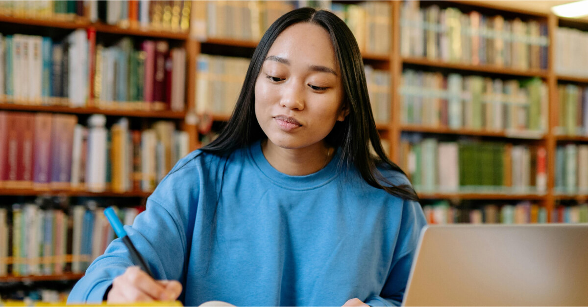 Woman Sitting Studying In Library